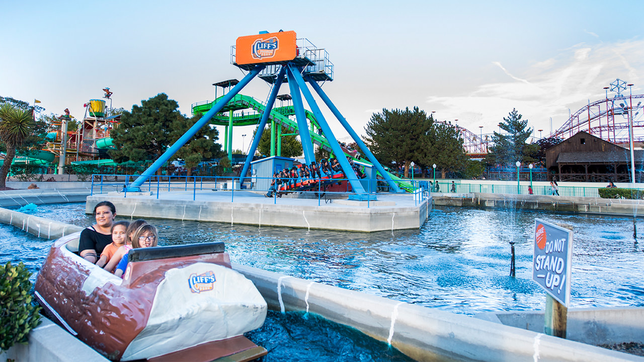 Guests on the Rocky Mountain Rapids in front of the Sidewinder