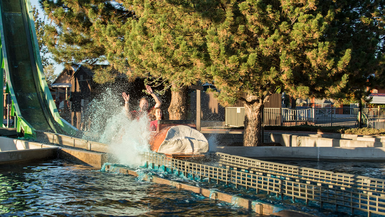 Guests getting splashed on the Rocky Mountain Rapids log ride
