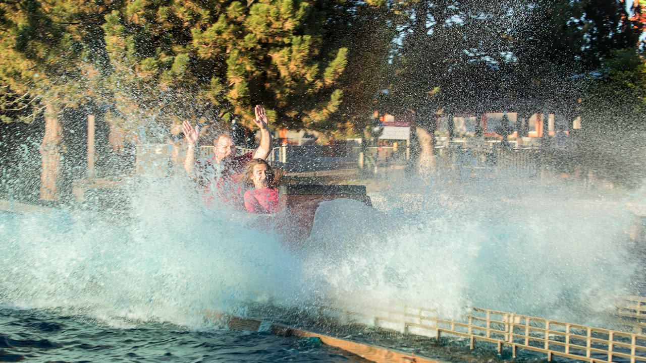 Guests getting splashed on the Rocky Mountain Rapids log ride