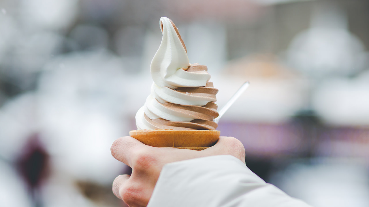 An ice cream cone with vanilla and chocolate