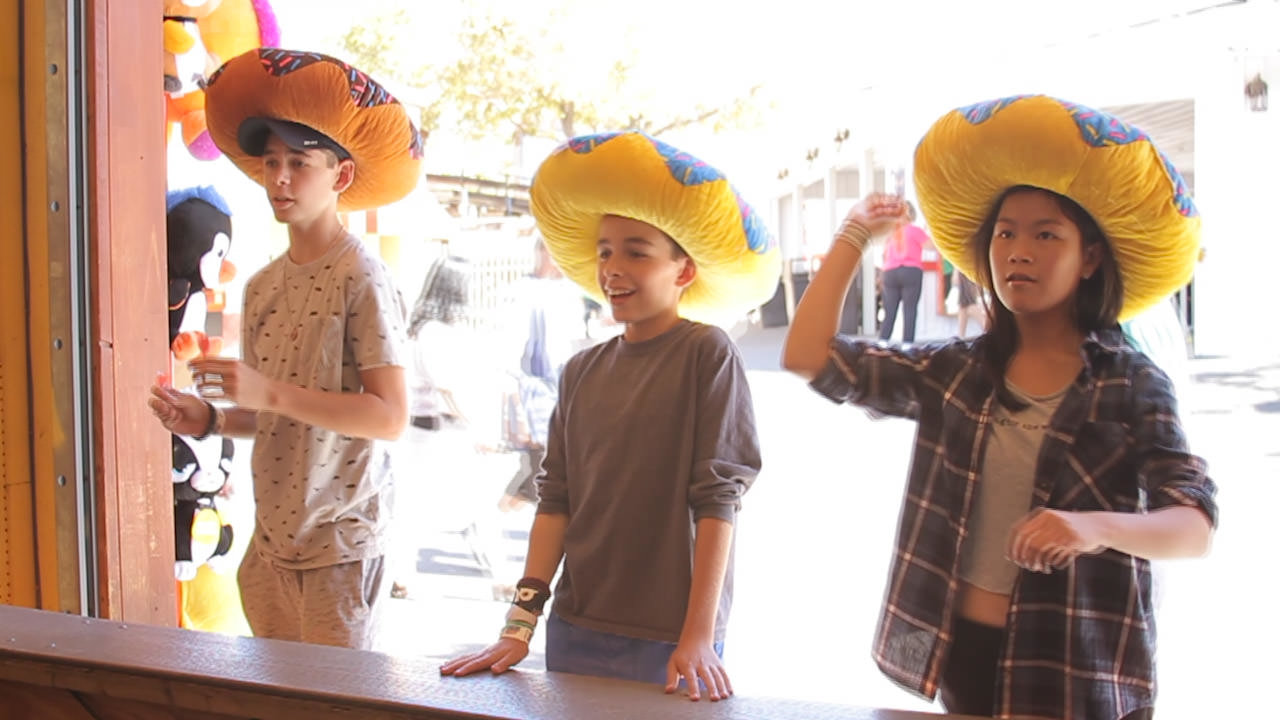 Guests playing Pop'em while wearing funny hats