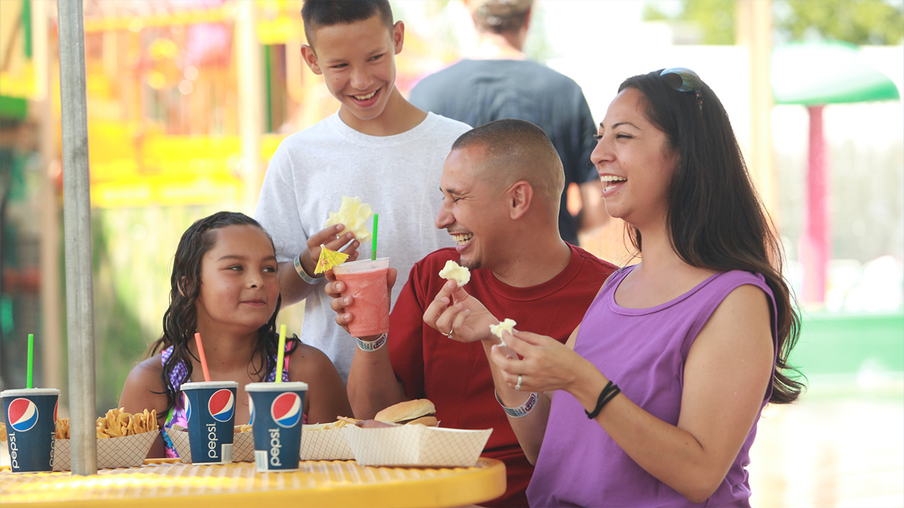 A family enjoying some treats including Pepsi and a pink smoothie